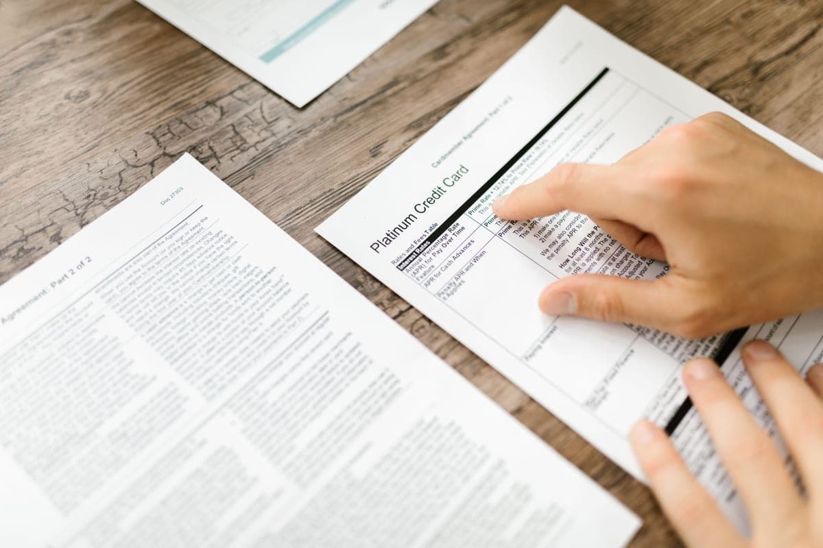 Printed care guidance sheets spread on a table beside a tape measure