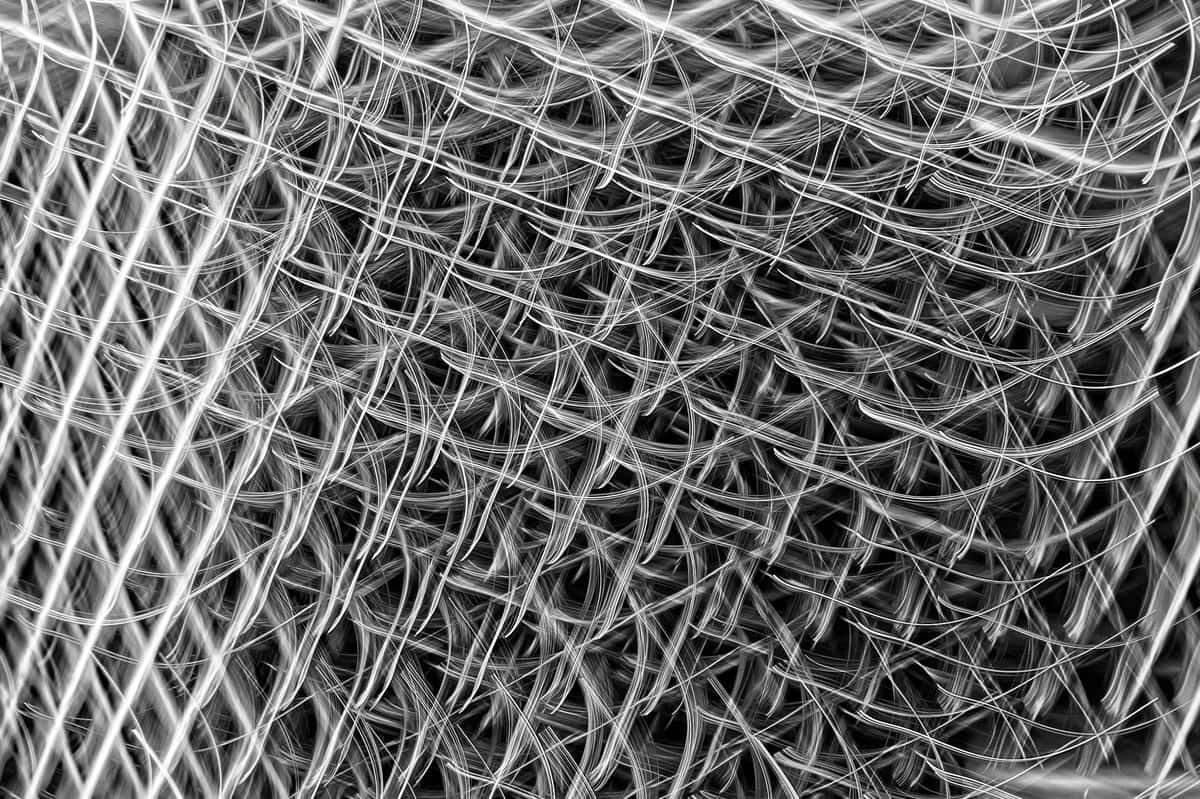 Close-up of powder-coated steel wire mesh and galvanized wire side by side