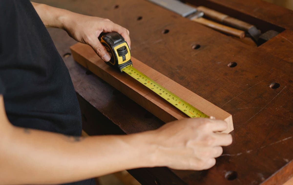 A tape measure laid across the base of a small-animal enclosure