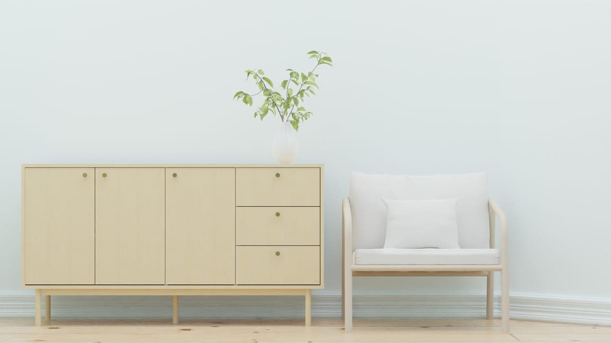 A small-animal enclosure on a low sideboard away from a window